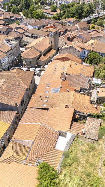 Aerial view of historic town with terracotta rooftops stone buildings and a church tower in the old town center Allariz Province of Ourense Spain. Aerial view of historic town with terracotta rooftops stone buildings and a church tower in the old town center Allariz Province of Ourense Spain.