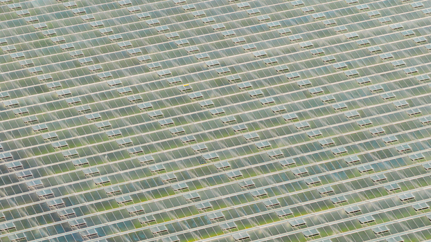 Aerial view of a large industrial greenhouse complex with glass panels and open ventilation windows Hrusky South Moravian Region Czechia. Aerial view of a large industrial greenhouse complex with glass panels and open ventilation windows Hrusky South Moravian Region Czechia.