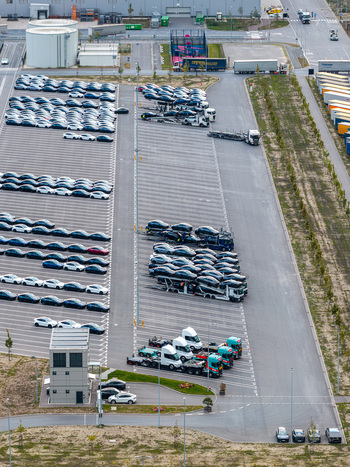 Aerial view of Tesla Gigafactory Berlin Brandenburg with rows of parked electric vehicles and car transport trucks at the logistics facility in Grunheide Brandenburg Germany. Aerial view of Tesla Gigafactory Berlin Brandenburg with rows of parked electric vehicles and car transport trucks at the logistics facility in Grunheide Brandenburg Germany.