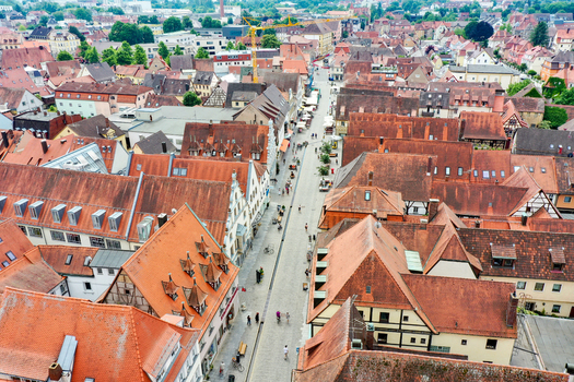 Aerial view of historic red tiled rooftops and a central pedestrian street with people walking in the old town of Forchheim Bavaria Germany. Aerial view of historic red tiled rooftops and a central pedestrian street with people walking in the old town of Forchheim Bavaria Germany.