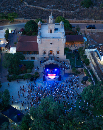 Northern Region Malta 17 September 2026 Aerial view of Castello Zamittello featuring a crowd of people gathered for an outdoor event with a stage illuminated by blue lights. Northern Region Malta 17 September 2026 Aerial view of Castello Zamittello featuring a crowd of people gathered for an outdoor event with a stage illuminated by blue lights.