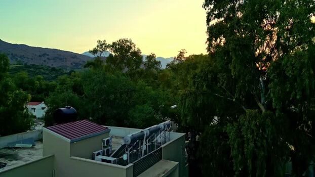 Aerial view of rooftop with solar heater in Crete Greece.