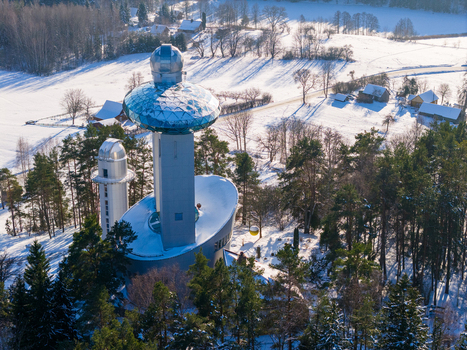 Aerial view of the Lithuanian Museum of Ethnocosmology with its futuristic glass domes and observatory towers surrounded by snow covered pine forests in Kulionys Utenos apskritis Lithuania.