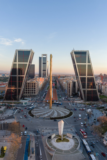 Aerial view of the Puerta de Europa towers and the Obelisco de la Caja at Plaza Castilla featuring skyscrapers busy traffic and urban streets in Madrid Comunidad de Madrid Spain. Aerial view of the Puerta de Europa towers and the Obelisco de la Caja at Plaza Castilla featuring skyscrapers busy traffic and urban streets in Madrid Comunidad de Madrid Spain.