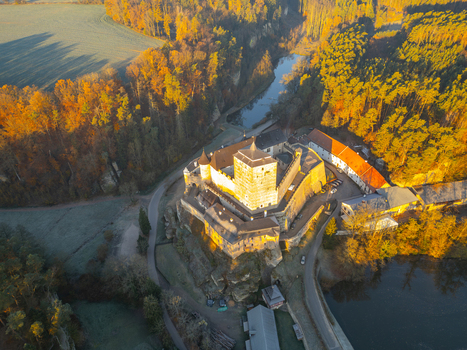 Aerial view of Kost Castle surrounded by autumn forests and a river in the golden hour light in Libosovice Kralovehradecky kraj Czechia. Aerial view of Kost Castle surrounded by autumn forests and a river in the golden hour light in Libosovice Kralovehradecky kraj Czechia.