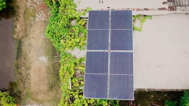 Aerial view of solar panels on a residential rooftop in India.