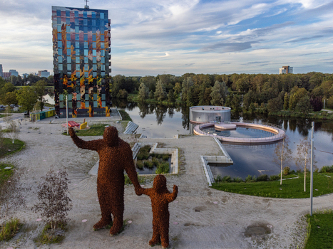 Aerial view of the weathered sculptures standing tall against the shimmering water and the Utopia Island Almere Flevoland Netherlands.