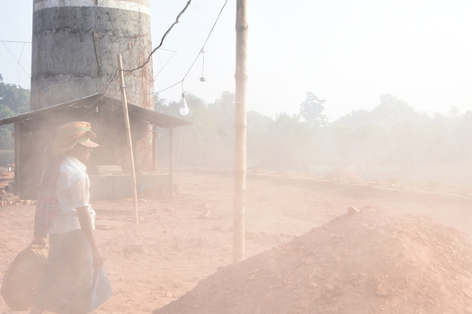 Kushtia District Khulna Division Bangladesh 28 November 2020 View of a worker carrying a basket near a brick kiln in a dusty rural landscape. Kushtia District Khulna Division Bangladesh 28 November 2020 View of a worker carrying a basket near a brick kiln in a dusty rural landscape.