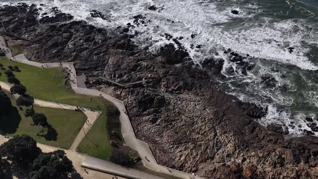 Aerial view of people walking along the coastline and pathways Portugal.