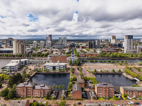 Aerial view of MediaCityUK featuring modern office buildings residential complexes and the Manchester Ship Canal in Salford England United Kingdom. Aerial view of MediaCityUK featuring modern office buildings residential complexes and the Manchester Ship Canal in Salford England United Kingdom.