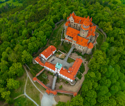 Aerial view of Bouzov Castle with its iconic red tiled roofs and stone towers nestled within a lush green forest Bouzov Olomoucky kraj Czechia. Aerial view of Bouzov Castle with its iconic red tiled roofs and stone towers nestled within a lush green forest Bouzov Olomoucky kraj Czechia.