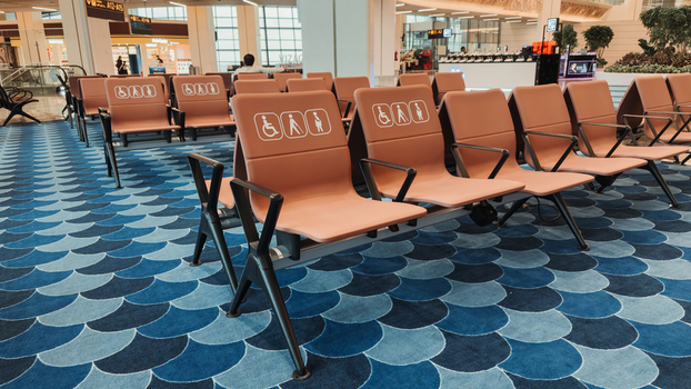 Bhogapuram India 22 August 2026 View of Alluri Sitarama Raju International Airport terminal seating with accessibility icons and blue patterned carpet. Bhogapuram India 22 August 2026 View of Alluri Sitarama Raju International Airport terminal seating with accessibility icons and blue patterned carpet.