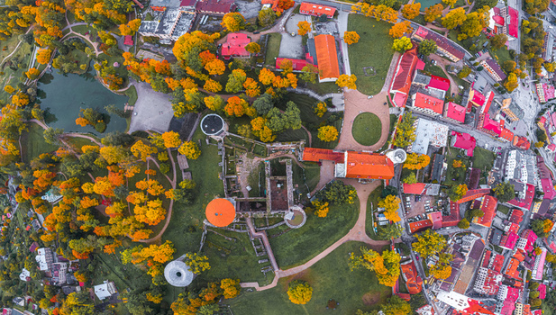 Aerial view of Cesis Castle surrounded by vibrant autumn foliage historic stone ruins and park paths in the town of Cesis Cesis Municipality Latvia. Aerial view of Cesis Castle surrounded by vibrant autumn foliage historic stone ruins and park paths in the town of Cesis Cesis Municipality Latvia.