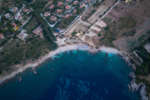 Aerial view of Riserva Naturale Orientata dello Zingaro with turquoise waters rocky coastline and nearby villas in San Vito Lo Capo Sicilia Italy. Aerial view of Riserva Naturale Orientata dello Zingaro with turquoise waters rocky coastline and nearby villas in San Vito Lo Capo Sicilia Italy.