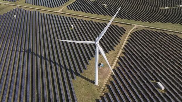 Aerial view of wind turbine and solar farm in United Kingdom. Aerial view of wind turbine and solar farm in United Kingdom.