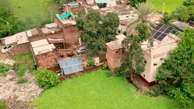 Aerial view of solar panels on residential rooftops in India.