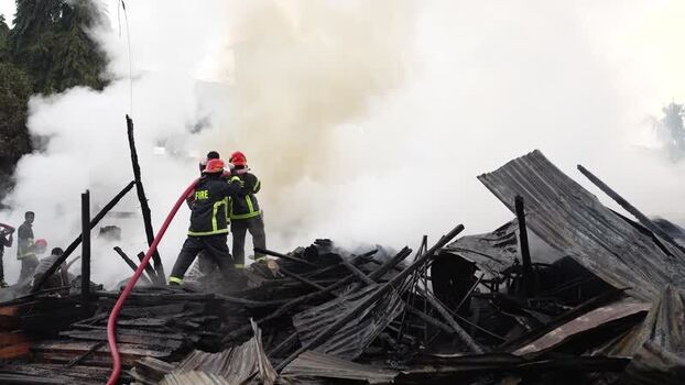 View of firefighters battling a large fire in Khagrachari Bangladesh. View of firefighters battling a large fire in Khagrachari Bangladesh.