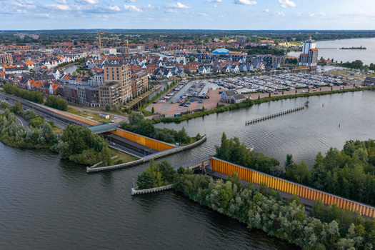 Aerial view of Aquaduct Veluwemeer with a road passing beneath the water boats in the marina and the town of Harderwijk in Harderwijk Gelderland Netherlands.