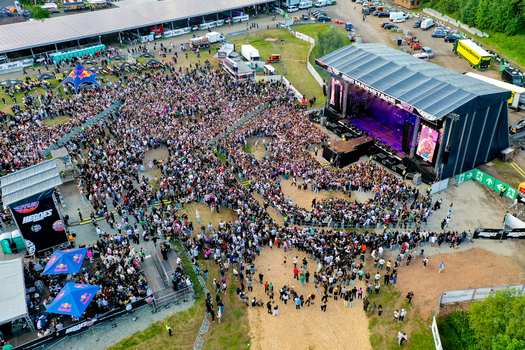 Geiselwind Germany 20 June 2025 Aerial view of Heroes Festival Geiselwind with a large crowd gathered in front of the main stage and event tents.