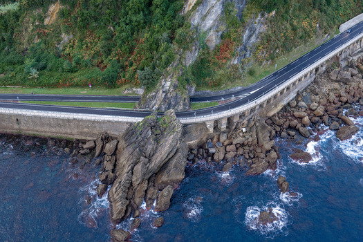 Aerial view of the coastal road winding along the rocky cliffs and the sea in Getaria Basque Country Spain.