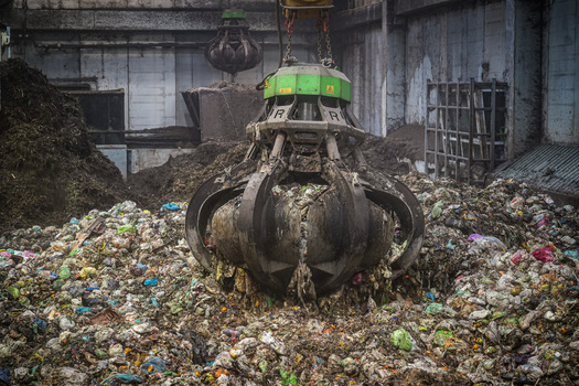 View of a mechanical grapple claw lifting organic waste at the Forsu Iren treatment plant in Reggio nell Emilia Emilia Romagna Italy. View of a mechanical grapple claw lifting organic waste at the Forsu Iren treatment plant in Reggio nell Emilia Emilia Romagna Italy.