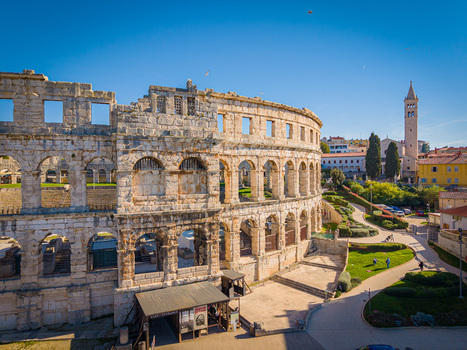 Aerial view of the ancient Roman amphitheater the Pula Arena stands majestically against the clear blue sky a testament to history Pula Istria County Croatia.