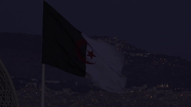Aerial view of the Algerian flag waving at night Algeria.
