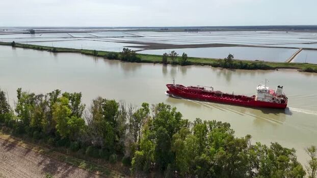 Aerial view of a red cargo ship on the Guadalquivir river Spain. Aerial view of a red cargo ship on the Guadalquivir river Spain.