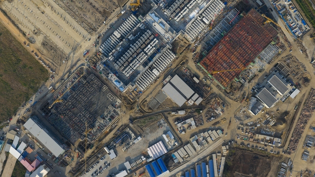 Aerial view of the Bridge Data Center under construction with cranes building foundations and industrial equipment in Khlong Tamru Chon Buri Thailand. Aerial view of the Bridge Data Center under construction with cranes building foundations and industrial equipment in Khlong Tamru Chon Buri Thailand.