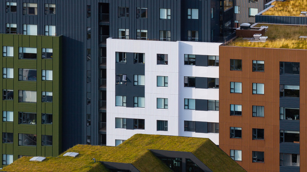 Aerial view of a modern apartment complex with colorful facades and green roofs in Iceland. Aerial view of a modern apartment complex with colorful facades and green roofs in Iceland.