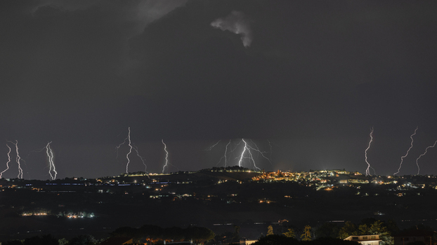 View of multiple lightning strikes illuminating the night sky over Morrovalle Marche Italy.