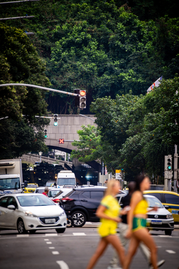 Rio de Janeiro Brazil 13 June 2026 View of people in yellow and green jerseys crossing a busy street with traffic near a tunnel entrance and lush trees during the World Cup 2026.