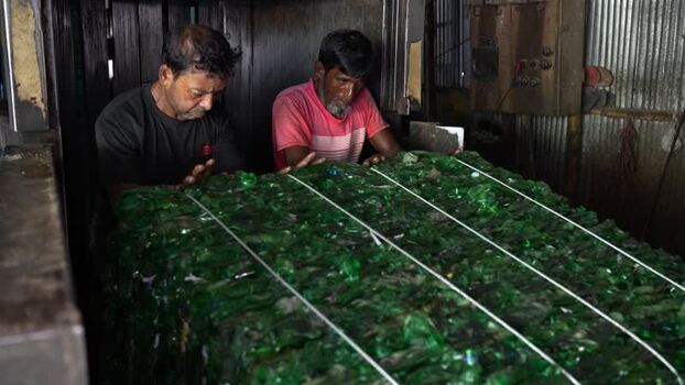 View of workers processing plastic bottles in Bogura Bangladesh. View of workers processing plastic bottles in Bogura Bangladesh.
