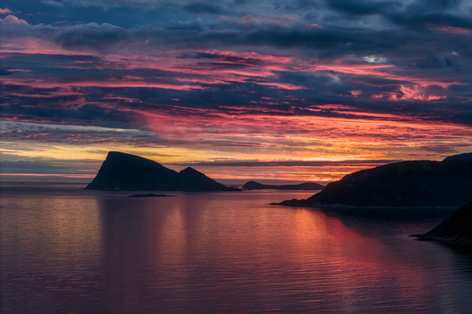 Aerial view of Sommaroy island landscape at sunset with dramatic colorful clouds reflecting on the calm sea in Sommaroy Troms Norway. Aerial view of Sommaroy island landscape at sunset with dramatic colorful clouds reflecting on the calm sea in Sommaroy Troms Norway.