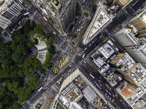 Aerial view of the Flatiron Building at the intersection of Broadway and Fifth Avenue surrounded by the dense urban grid of Manhattan New York New York United States. Aerial view of the Flatiron Building at the intersection of Broadway and Fifth Avenue surrounded by the dense urban grid of Manhattan New York New York United States.