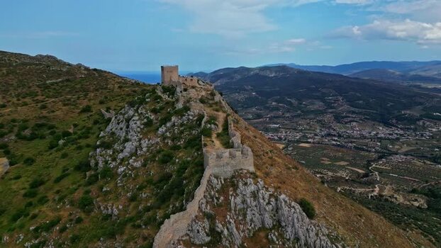 Aerial view of a medieval fortress on a hilltop in Greece.