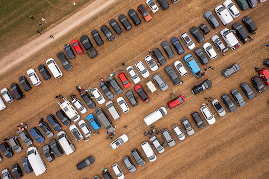 Aerial view of the Open Beatz Festival parking area with rows of cars parked in a field and people walking between vehicles in Herzogenaurach Bayern Germany. Aerial view of the Open Beatz Festival parking area with rows of cars parked in a field and people walking between vehicles in Herzogenaurach Bayern Germany.