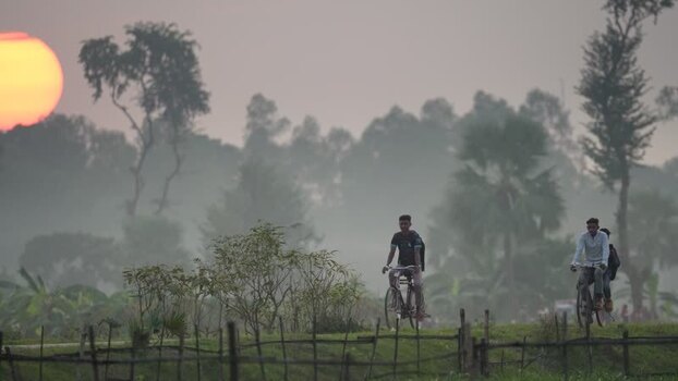 View of people riding bicycles at sunset in Bogura Bangladesh. View of people riding bicycles at sunset in Bogura Bangladesh.