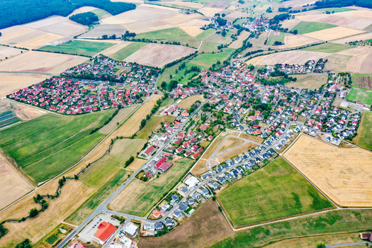 Aerial view of Munchaurach village with its historic church red tiled houses and surrounding agricultural fields in Aurachtal Bayern Germany. Aerial view of Munchaurach village with its historic church red tiled houses and surrounding agricultural fields in Aurachtal Bayern Germany.