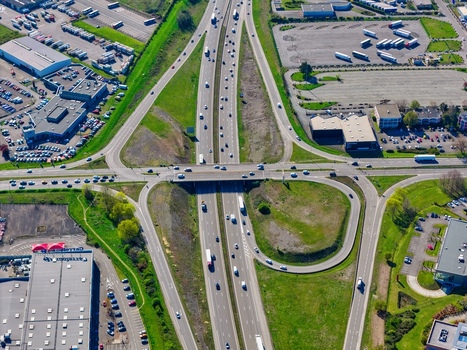 Aerial view of the vibrant green landscape interwoven with the concrete arteries of a bustling highway interchange a dance of nature and infrastructure Sausheim Grand Est France.