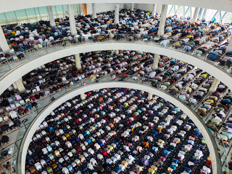 Dhaka Bangladesh 19 June 2026 Aerial view of a large mosque interior with many people praying in rows on multiple levels.
