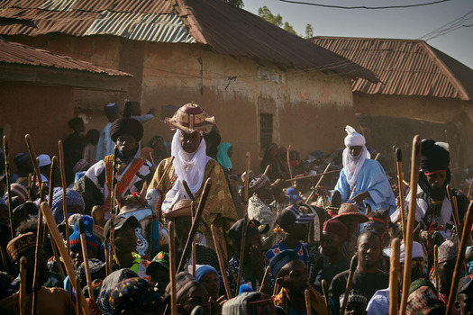 Zaria Nigeria 22 March 2026 View of traditionally adorned men their rich robes and staffs contrasting with the sun baked textured walls of homes. Zaria Nigeria 22 March 2026 View of traditionally adorned men their rich robes and staffs contrasting with the sun baked textured walls of homes.