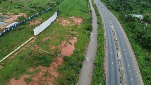 Aerial view of a highway passing through green landscape Nigeria.