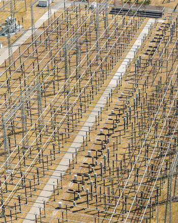Aerial view of Amprion Umspannwerk electrical substation with complex metal structures power lines and transformers in Pfungstadt Hessen Germany.