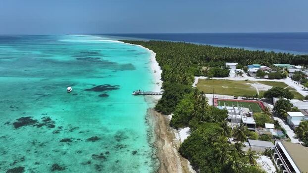Aerial view of the tropical island of Fulhadhoo with turquoise water Maldives. Aerial view of the tropical island of Fulhadhoo with turquoise water Maldives.