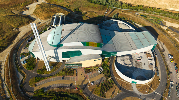 Aerial view of the Energy Recovery Facility in Bicester featuring its distinctive curved roof tall chimneys and surrounding industrial infrastructure Bicester England United Kingdom.