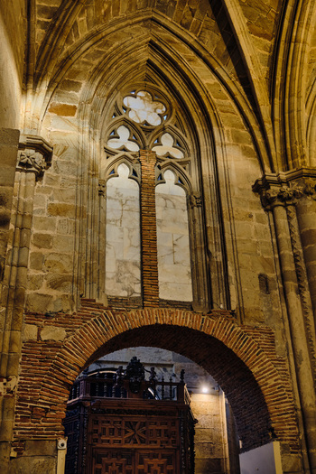 Plasencia Spain 03 December 2025 View of Catedral Nueva de Plasencia showing the intricate Gothic stone arches a large tracery window and historic brickwork details inside. Plasencia Spain 03 December 2025 View of Catedral Nueva de Plasencia showing the intricate Gothic stone arches a large tracery window and historic brickwork details inside.