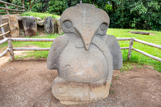 View of the ancient stone bird statue at San Agustin Archaeological Park featuring intricate carvings and weathered texture in San Agustin Huila Colombia.