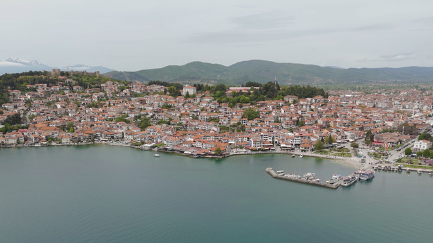 Aerial view of the historic old town of Ohrid with red tiled rooftops fortress and boats at the pier along the serene waters of Lake Ohrid Ohrid Municipality of Ohrid North Macedonia. Aerial view of the historic old town of Ohrid with red tiled rooftops fortress and boats at the pier along the serene waters of Lake Ohrid Ohrid Municipality of Ohrid North Macedonia.