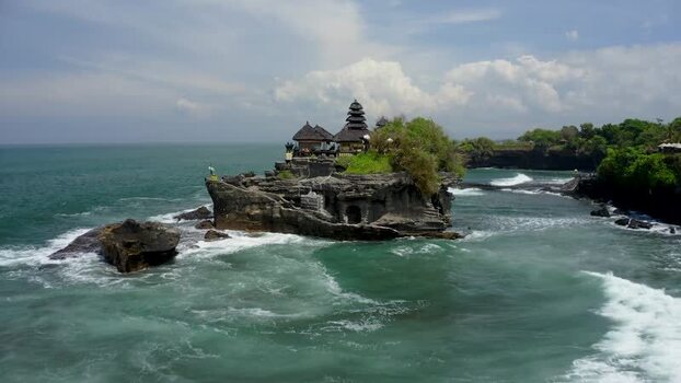 Aerial view of Tanah Lot temple on a rocky outcrop in Bali Indonesia.
